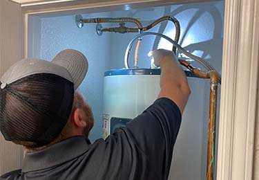 A home inspector inspecting a water heater.
